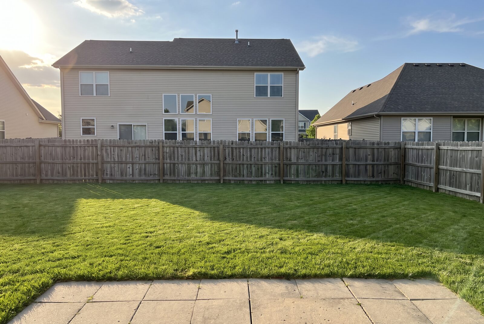 A photo of the exposed backyard today, the neighboring house looking straight in